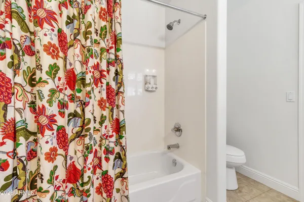a view of a porch with a table and chairs and garden
