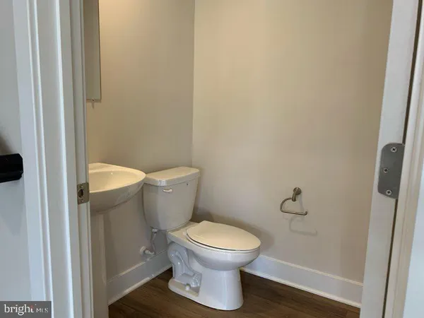 a white toilet sitting next to a shower