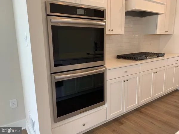 a kitchen with cabinets and appliances