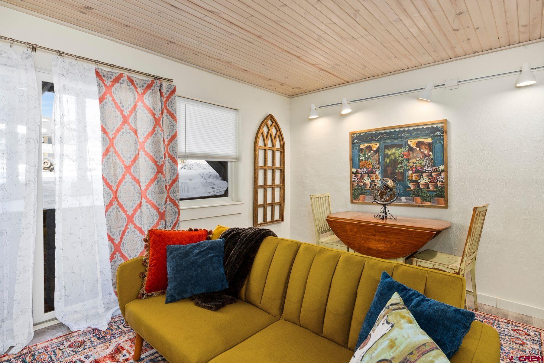 35 Emmons Road, Unit A Crested Butte, CO 81225 - Photo 3 of 28 a living room with furniture and a painting on the wall