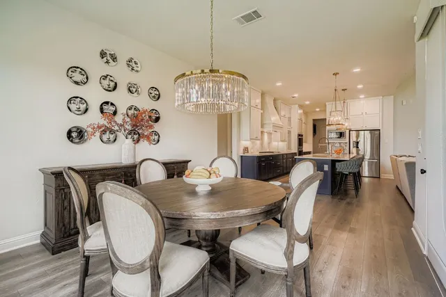 a view of a dining room with furniture wooden floor and chandelier