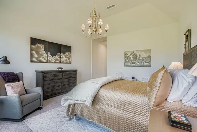 a spacious bedroom with a bed and a couch