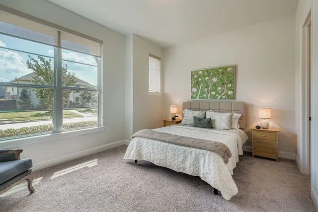 a bedroom with bed and a window