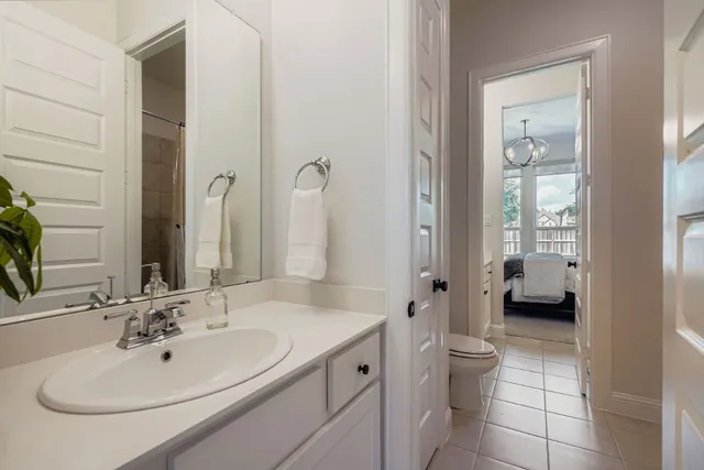 a spacious bathroom with a toilet sink and mirror