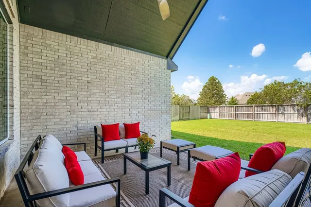 a backyard of a house with outdoor seating