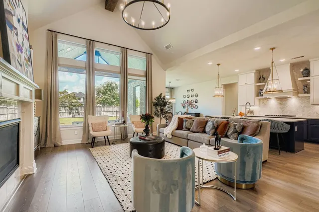 a living room with furniture a table and a large window