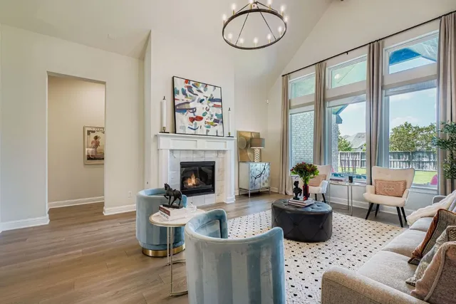 a living room with furniture a fireplace and a potted plant