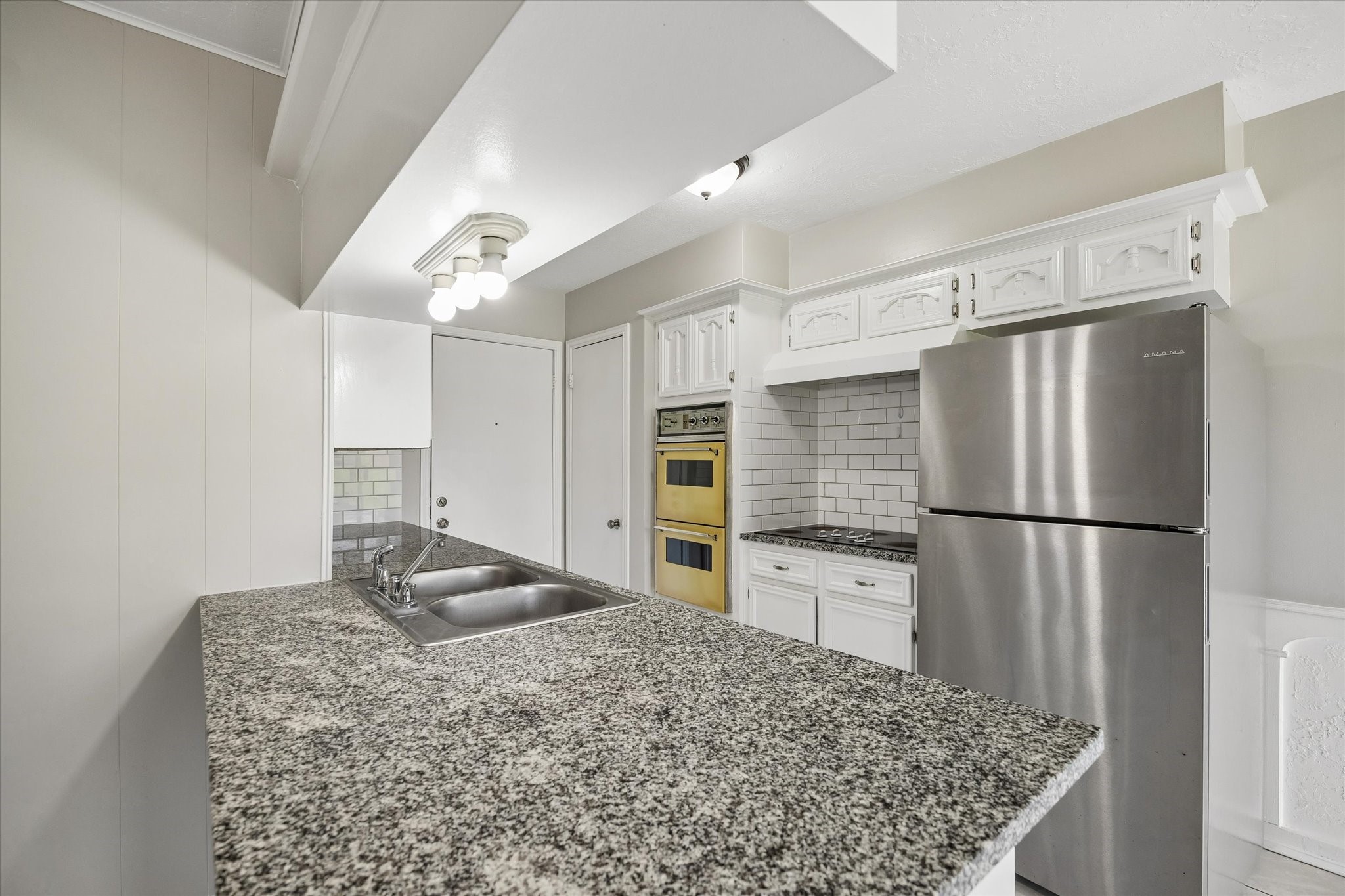 25114 Spring Ridge Drive Spring, TX 77386 - Photo 10 of 24 a kitchen with stainless steel appliances granite countertop a refrigerator and a stove top oven
