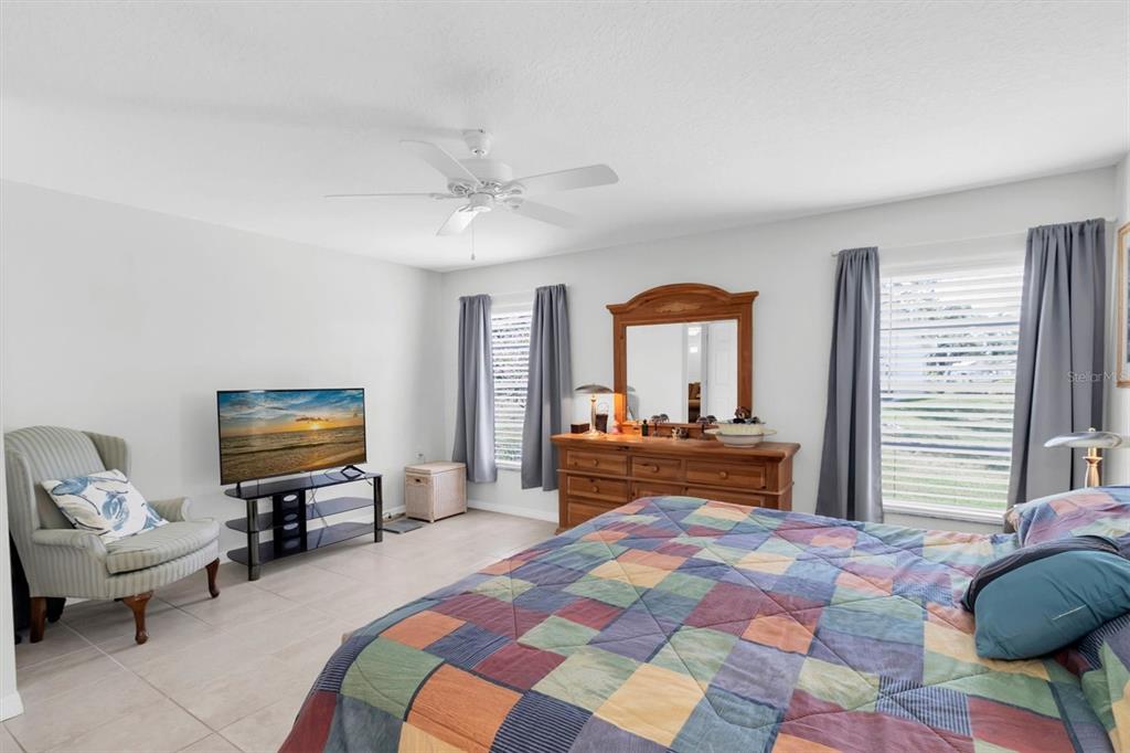 9052 Arundle Place New Port Richey, FL 34655 - Photo 16 of 57 a bedroom with a bed and a chandelier