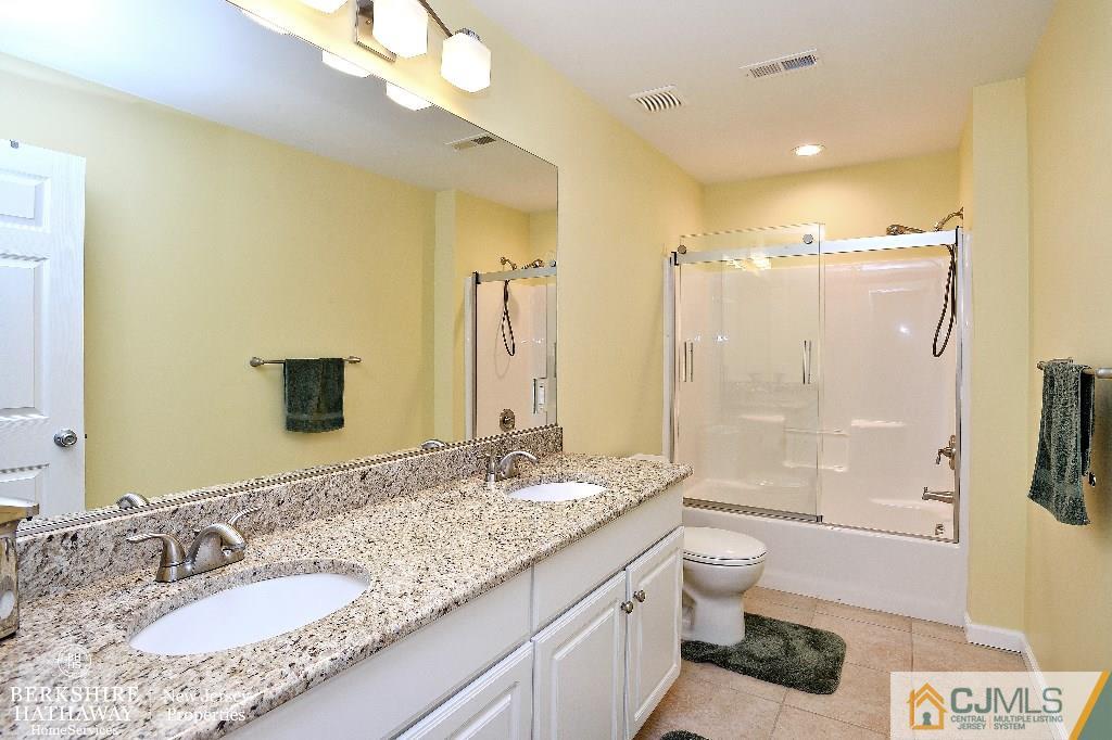 40 Edgewood Road Edison, NJ 08820 - Photo 22 of 25 a bathroom with a granite countertop double vanity sink mirror bathtub shower and toilet