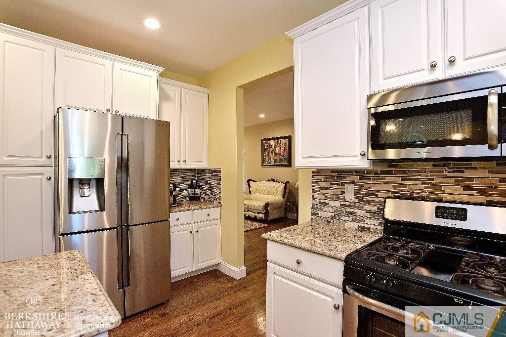 40 Edgewood Road Edison, NJ 08820 - Photo 8 of 25 a kitchen with granite countertop a refrigerator stove and microwave