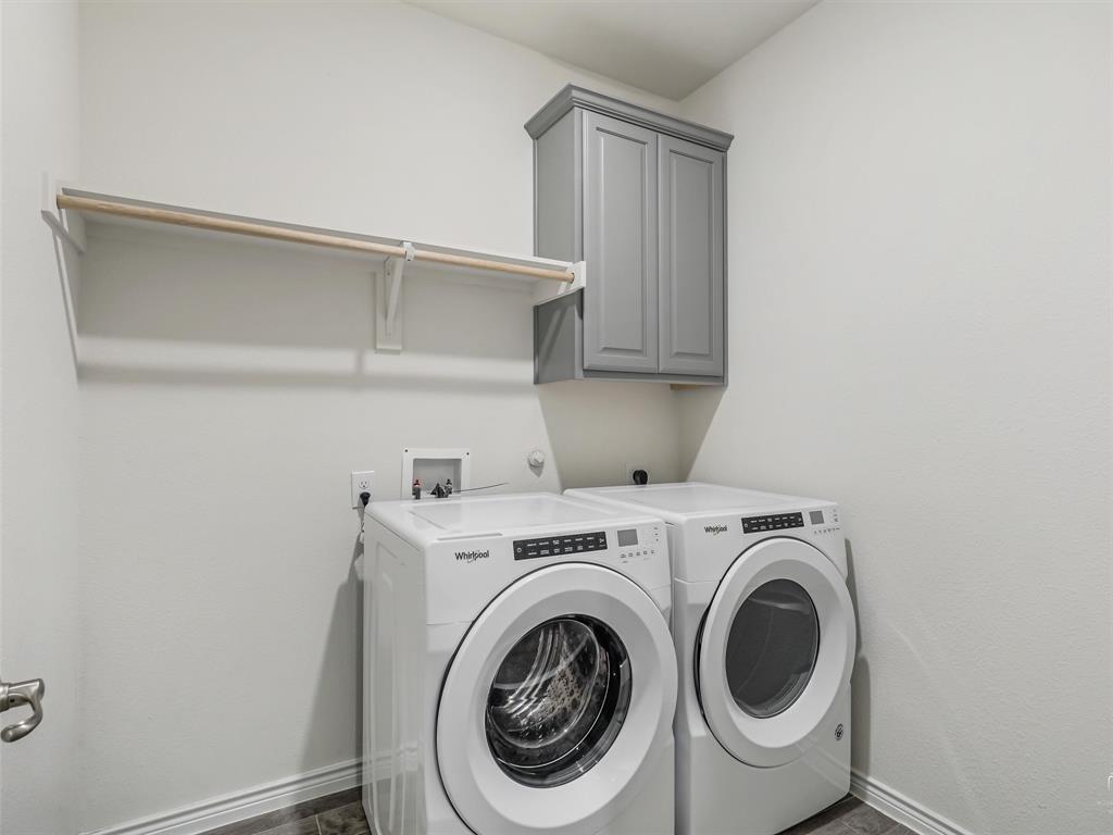 3024 Meredith Lane Forney, TX 75126 - Photo 21 of 29 Dedicated laundry space featuring a white shelf with a hanging rod, grey upper cabinetry, and tile flooring