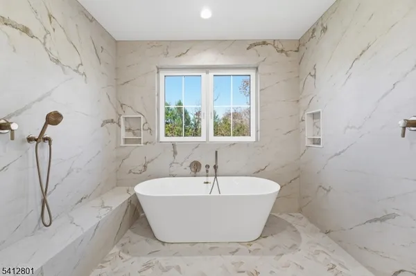 a white bath tub sitting next to a white sink