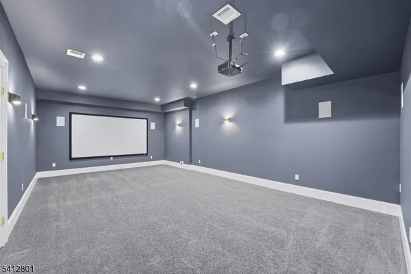 an empty room with projector and hallway
