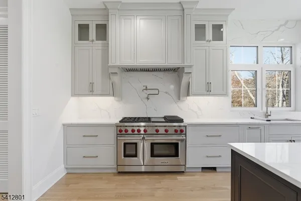a kitchen with granite countertop a stove and a sink