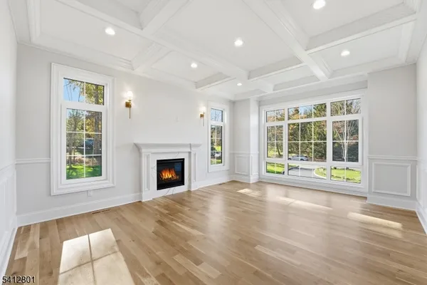 a view of an empty room with window and fire place