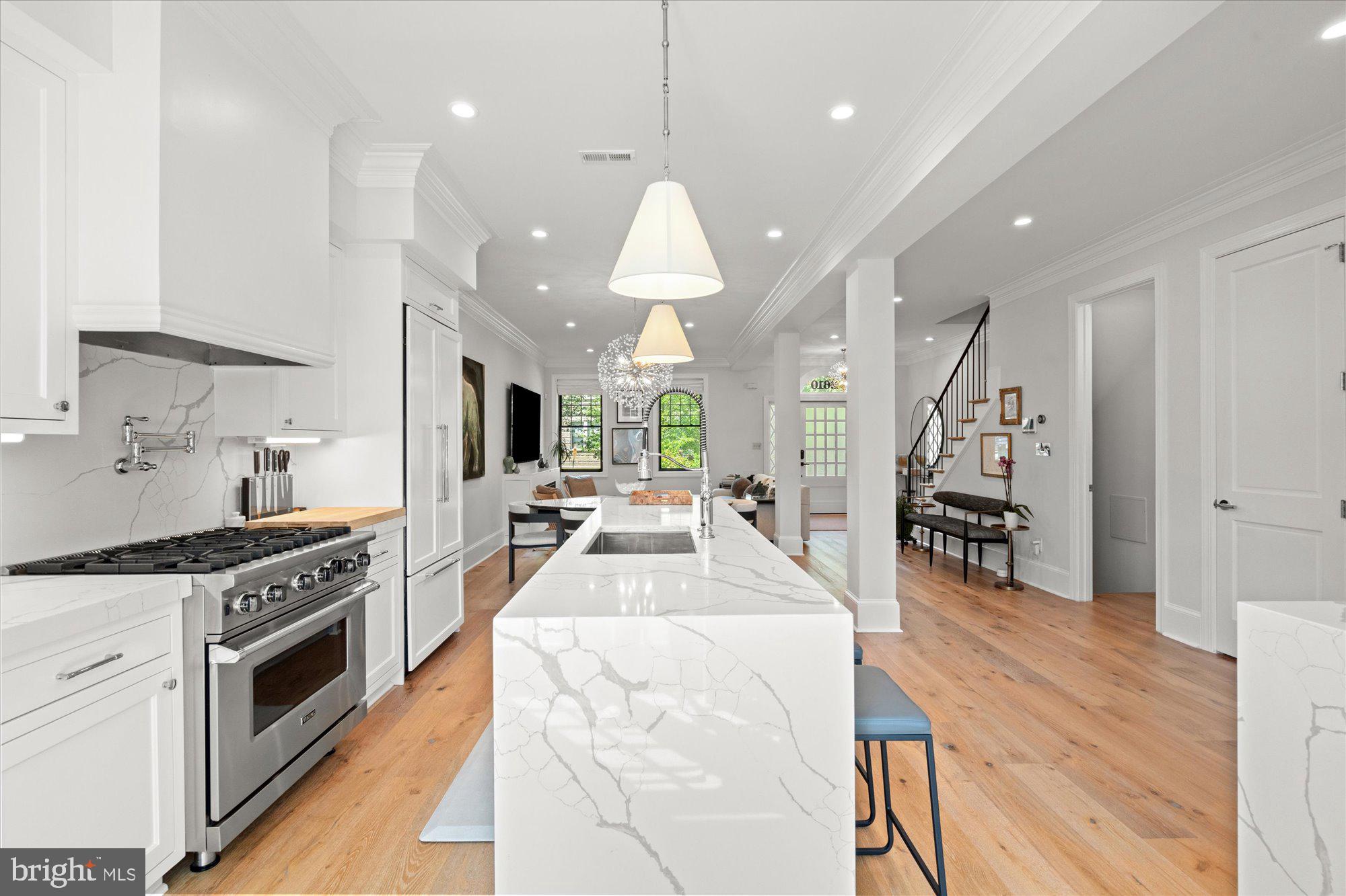 2610 Garfield Street Northwest Washington, DC 20008 - Photo 12 of 51 a large kitchen with stainless steel appliances kitchen island granite countertop a stove a sink a dining table and chairs