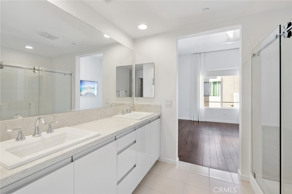 561 Rockefeller Irvine, CA 92612 - Photo 11 of 26 a bathroom with a double vanity sink and a mirror