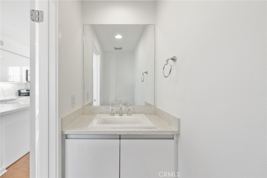 561 Rockefeller Irvine, CA 92612 - Photo 13 of 26 a bathroom with a sink and a mirror
