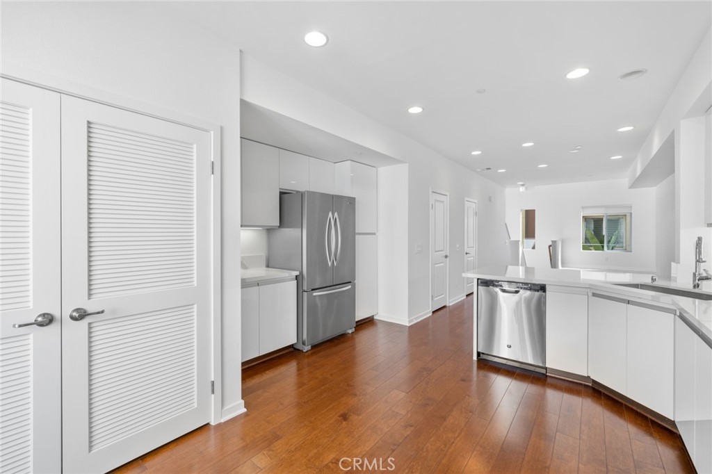 561 Rockefeller Irvine, CA 92612 - Photo 5 of 26 a large kitchen with a lot of counter space and wooden floor