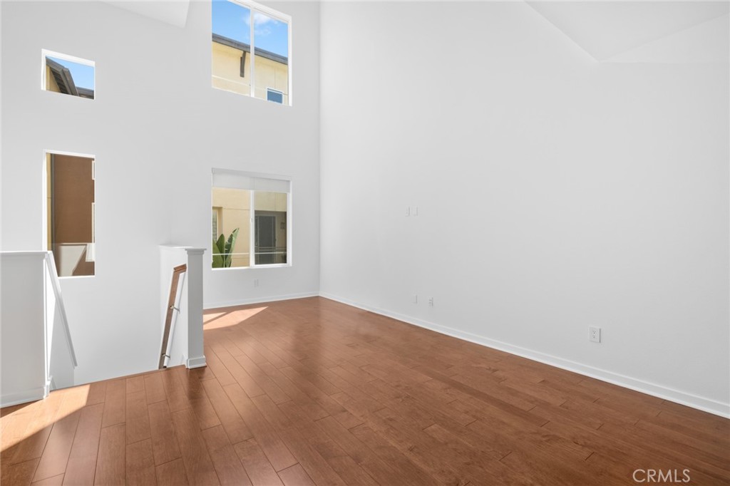 561 Rockefeller Irvine, CA 92612 - Photo 7 of 26 a view of a hallway with wooden floor and a bathroom