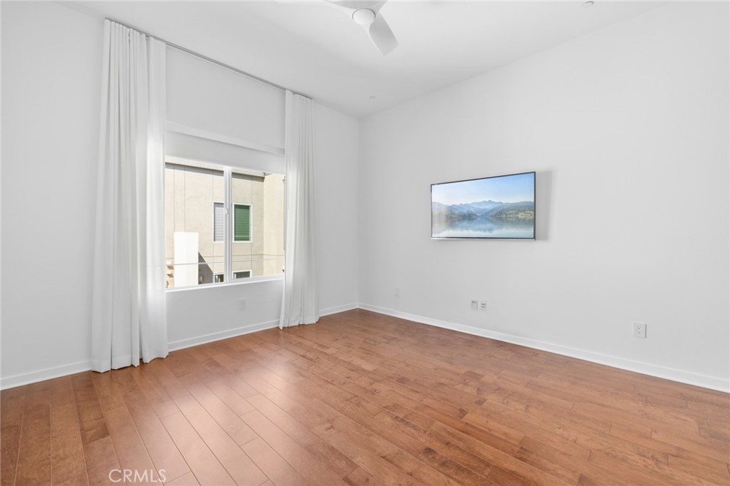 561 Rockefeller Irvine, CA 92612 - Photo 9 of 26 an empty room with wooden floor and windows