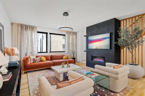 a living room with fireplace furniture and a flat screen tv
