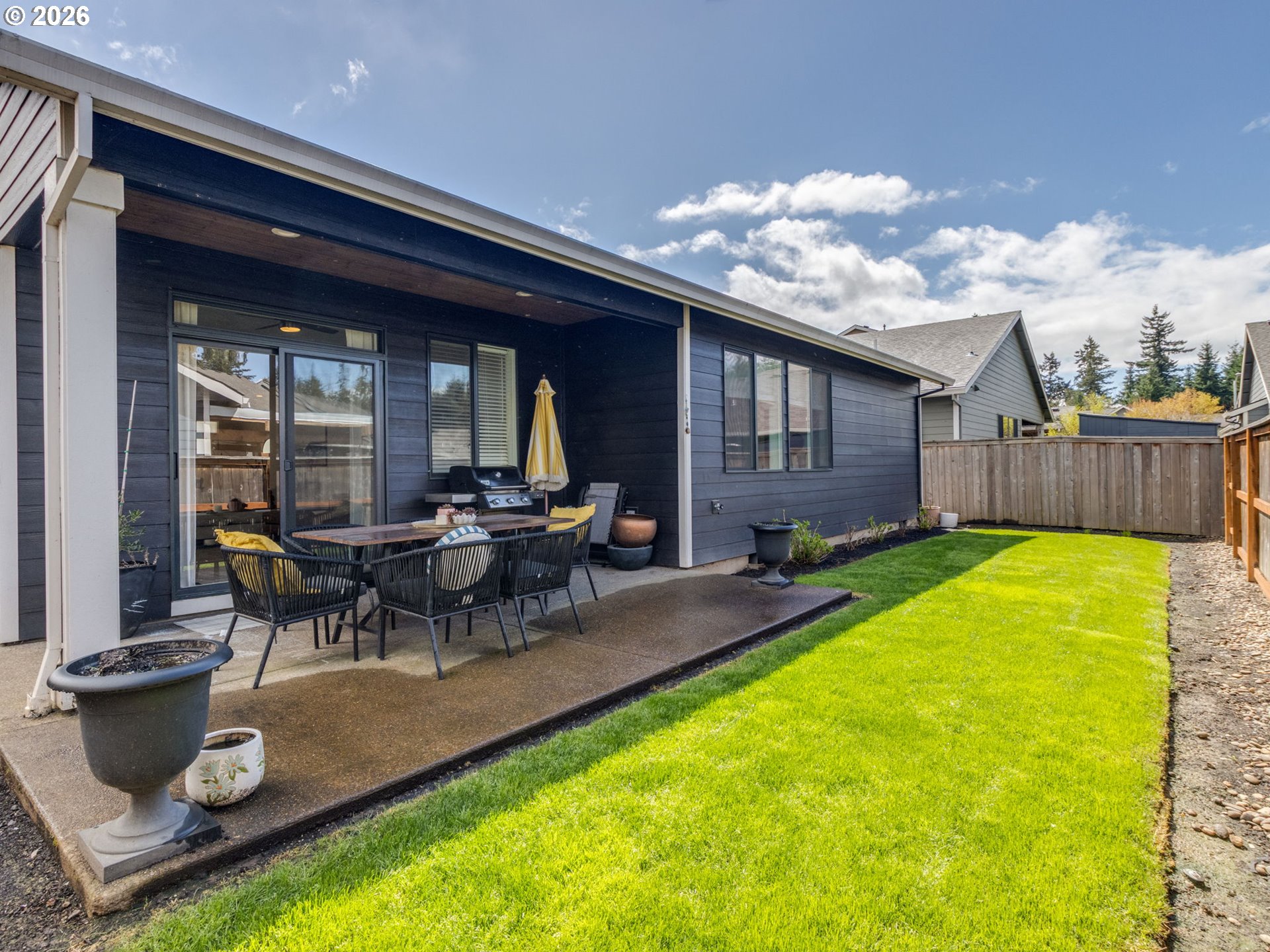 2893 4th Street Hubbard, OR 97032 - Photo 28 of 41 a view of a backyard with a patio and dining space