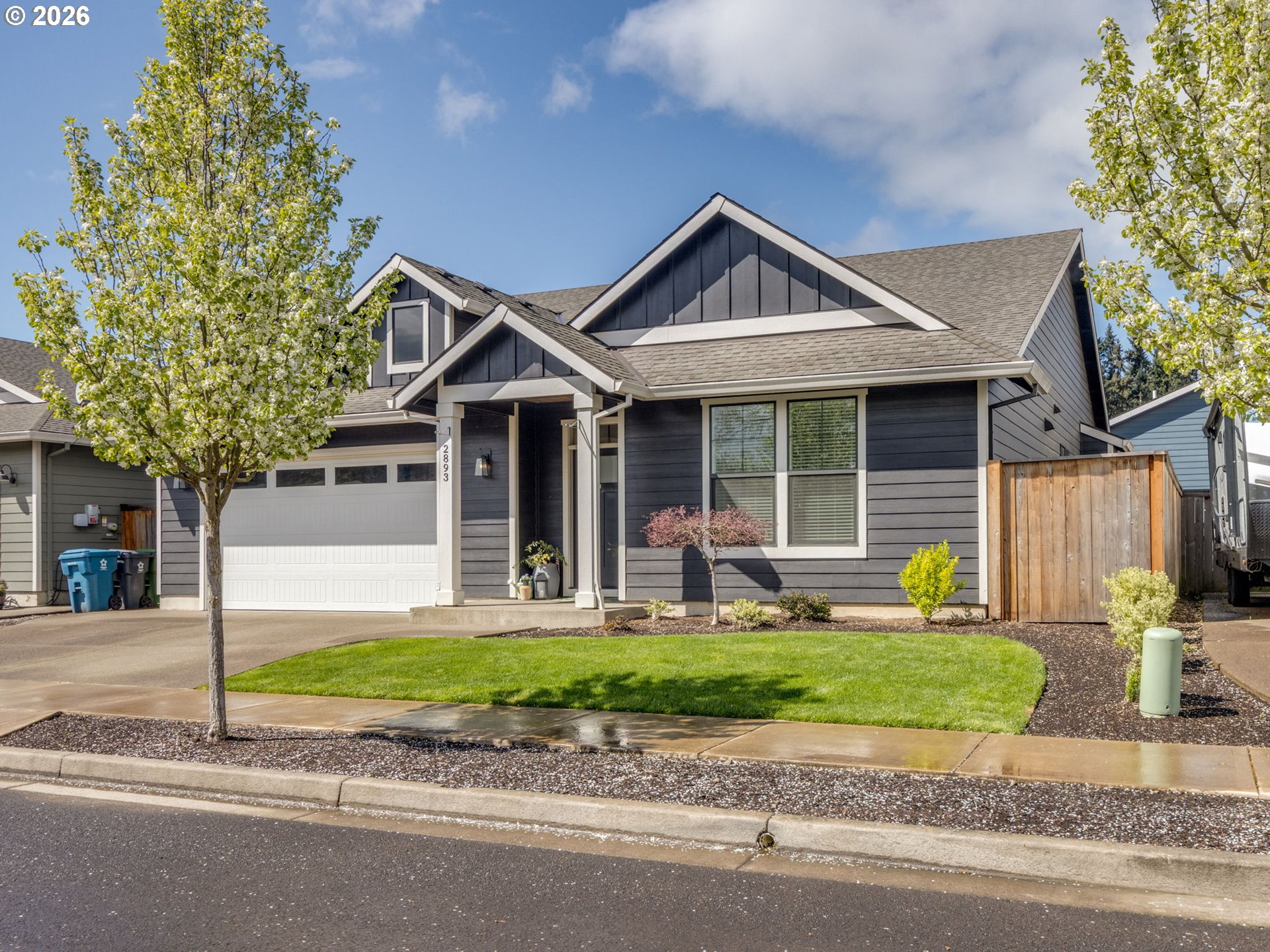 2893 4th Street Hubbard, OR 97032 - Photo 33 of 41 a front view of a house with a yard and garage