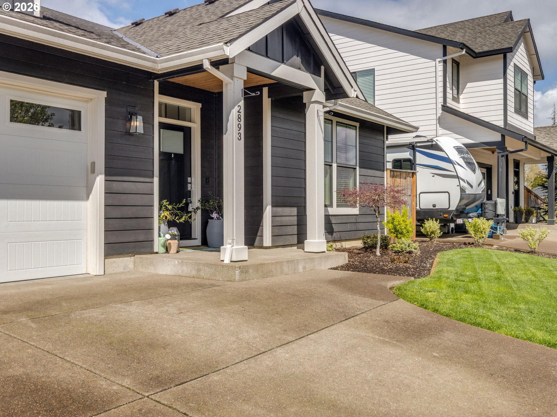 2893 4th Street Hubbard, OR 97032 - Photo 36 of 41 a front view of a house with a yard and garage