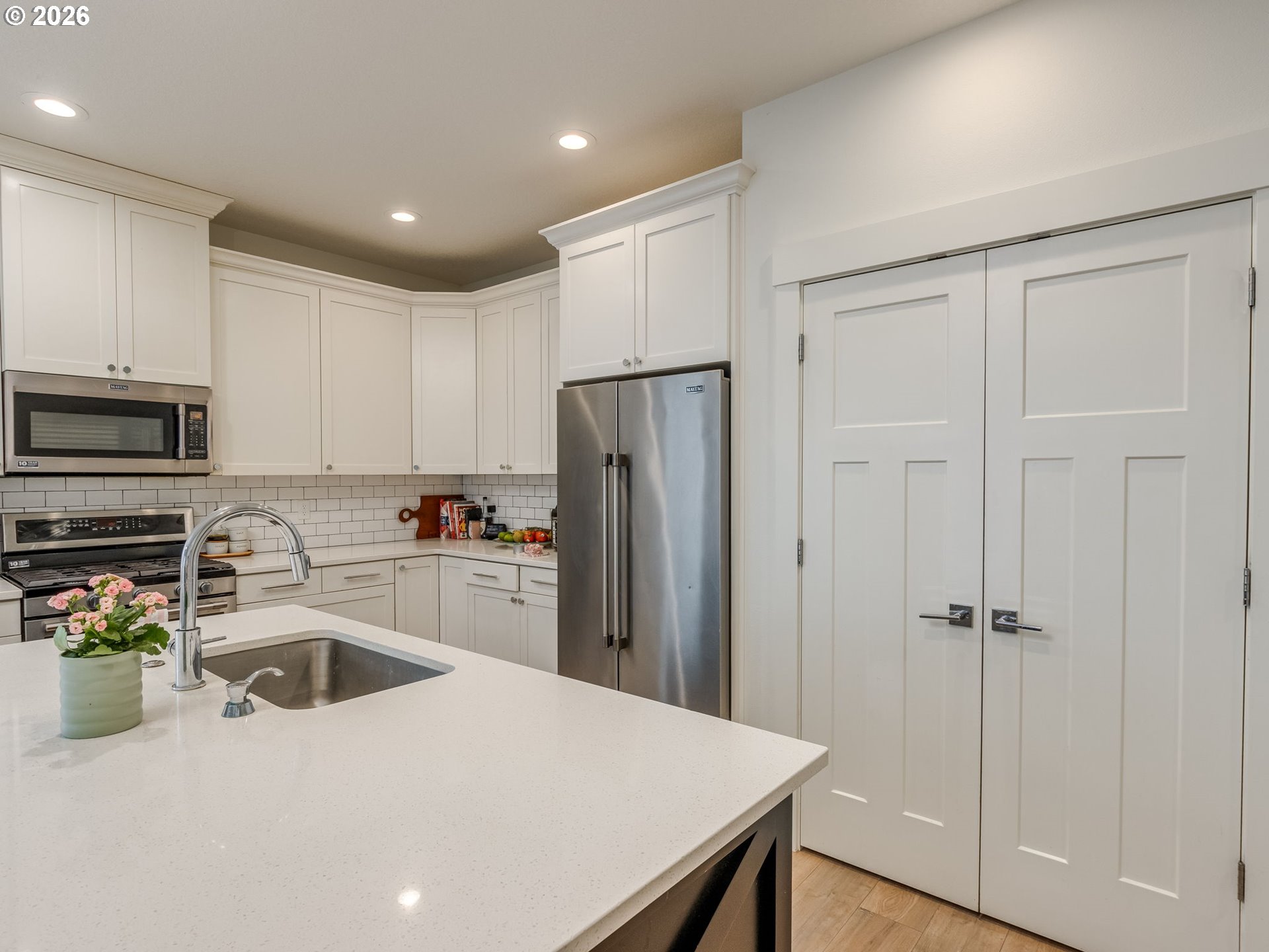 2893 4th Street Hubbard, OR 97032 - Photo 40 of 41 a kitchen with a sink a refrigerator and cabinets