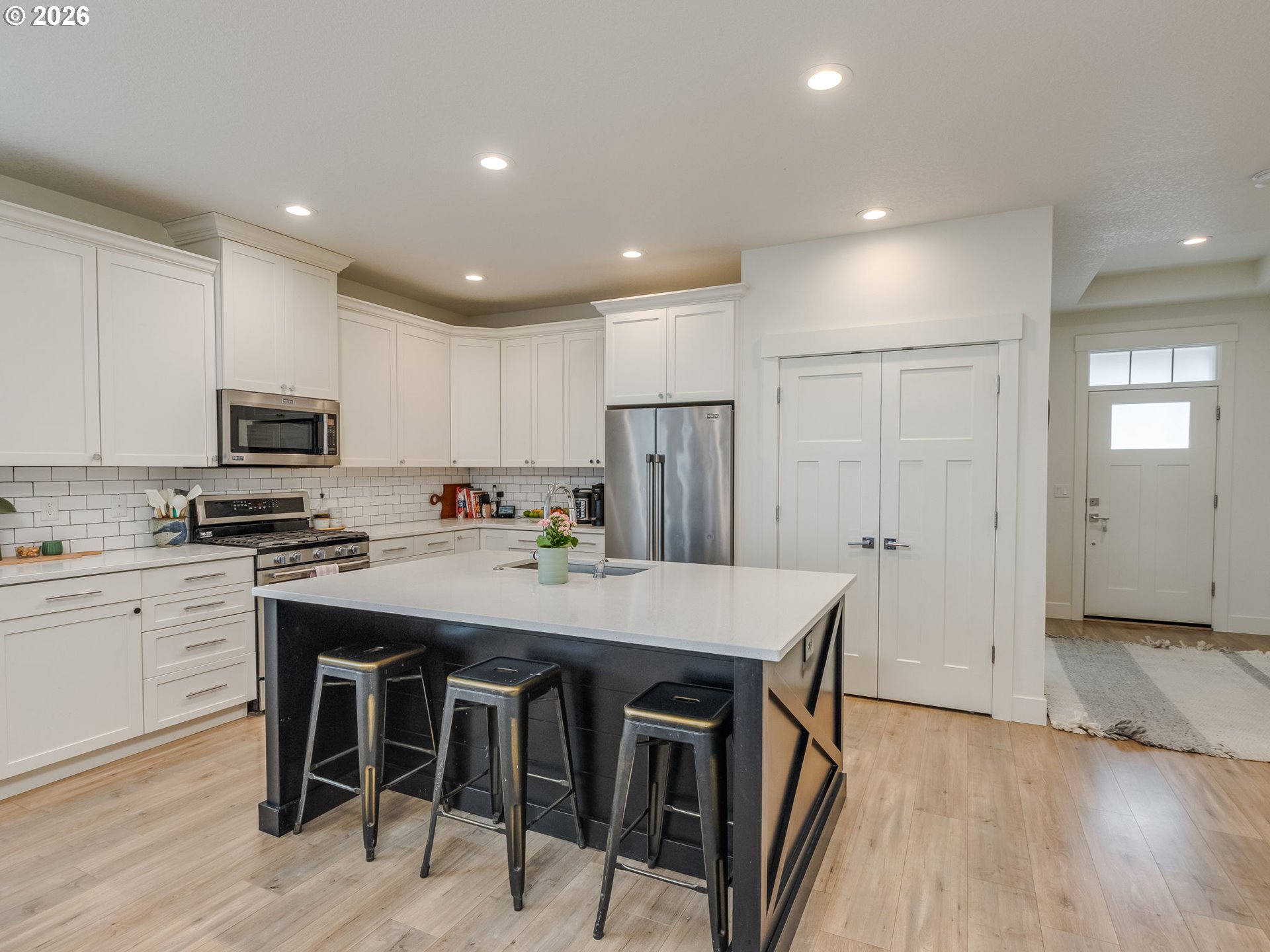2893 4th Street Hubbard, OR 97032 - Photo 41 of 41 a kitchen with stainless steel appliances granite countertop a table chairs sink refrigerator and cabinets