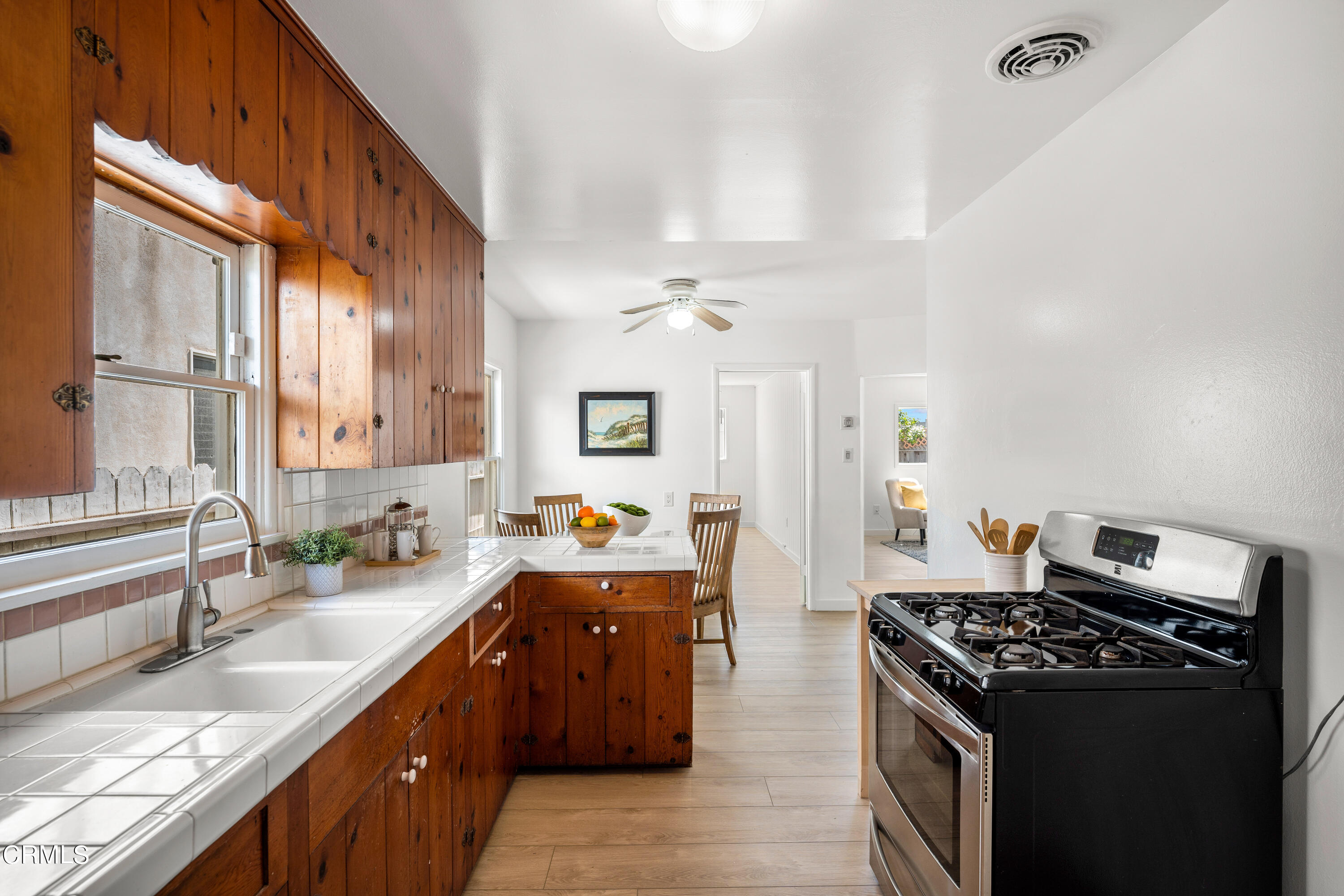 3652 Ocean Drive Oxnard, CA 93035 - Photo 12 of 28 a kitchen with stainless steel appliances granite countertop a sink stove and refrigerator