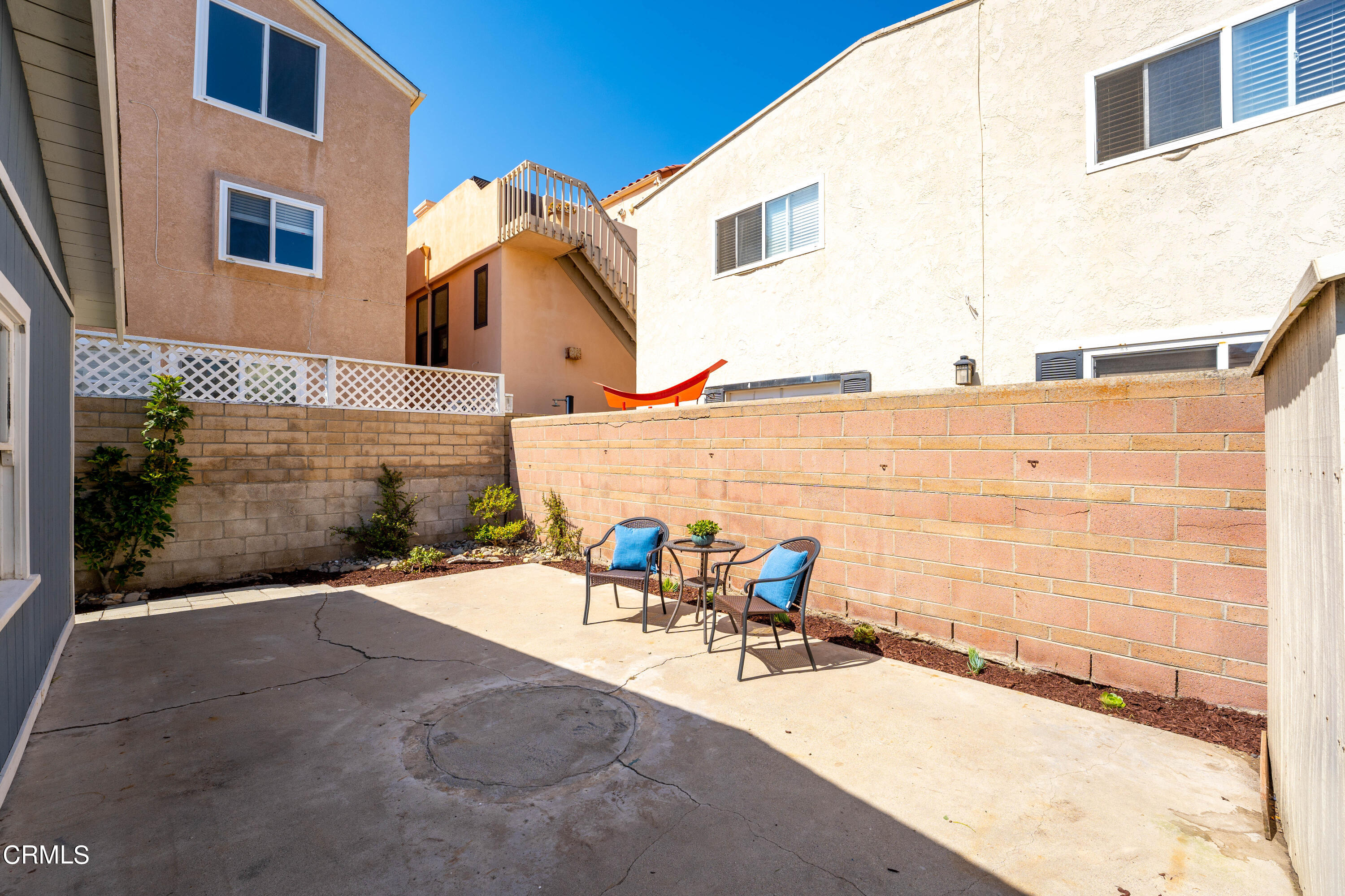 3652 Ocean Drive Oxnard, CA 93035 - Photo 20 of 28 a view of a patio with a table and chairs under an umbrella