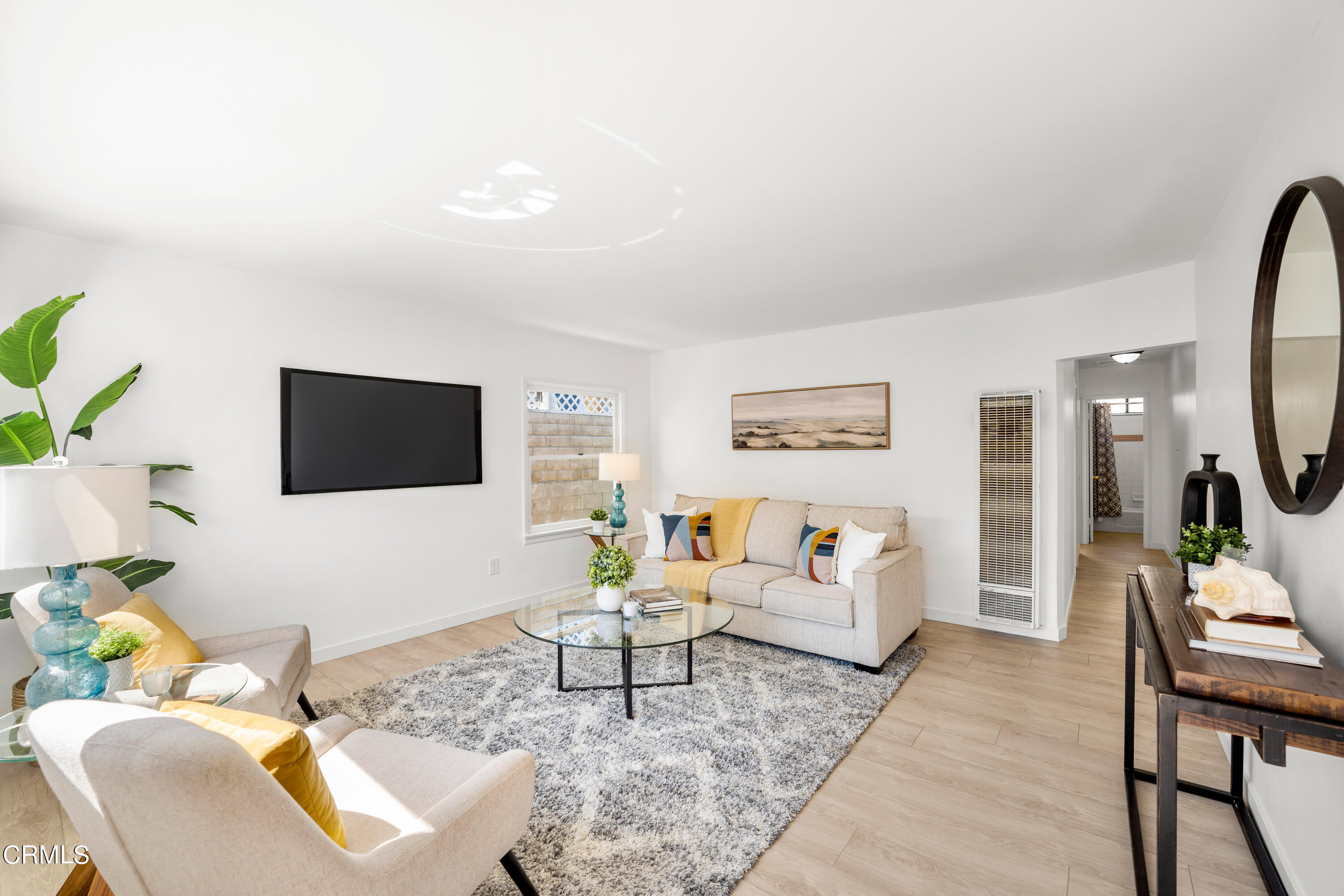 3652 Ocean Drive Oxnard, CA 93035 - Photo 2 of 28 a living room with furniture a rug and a flat screen tv