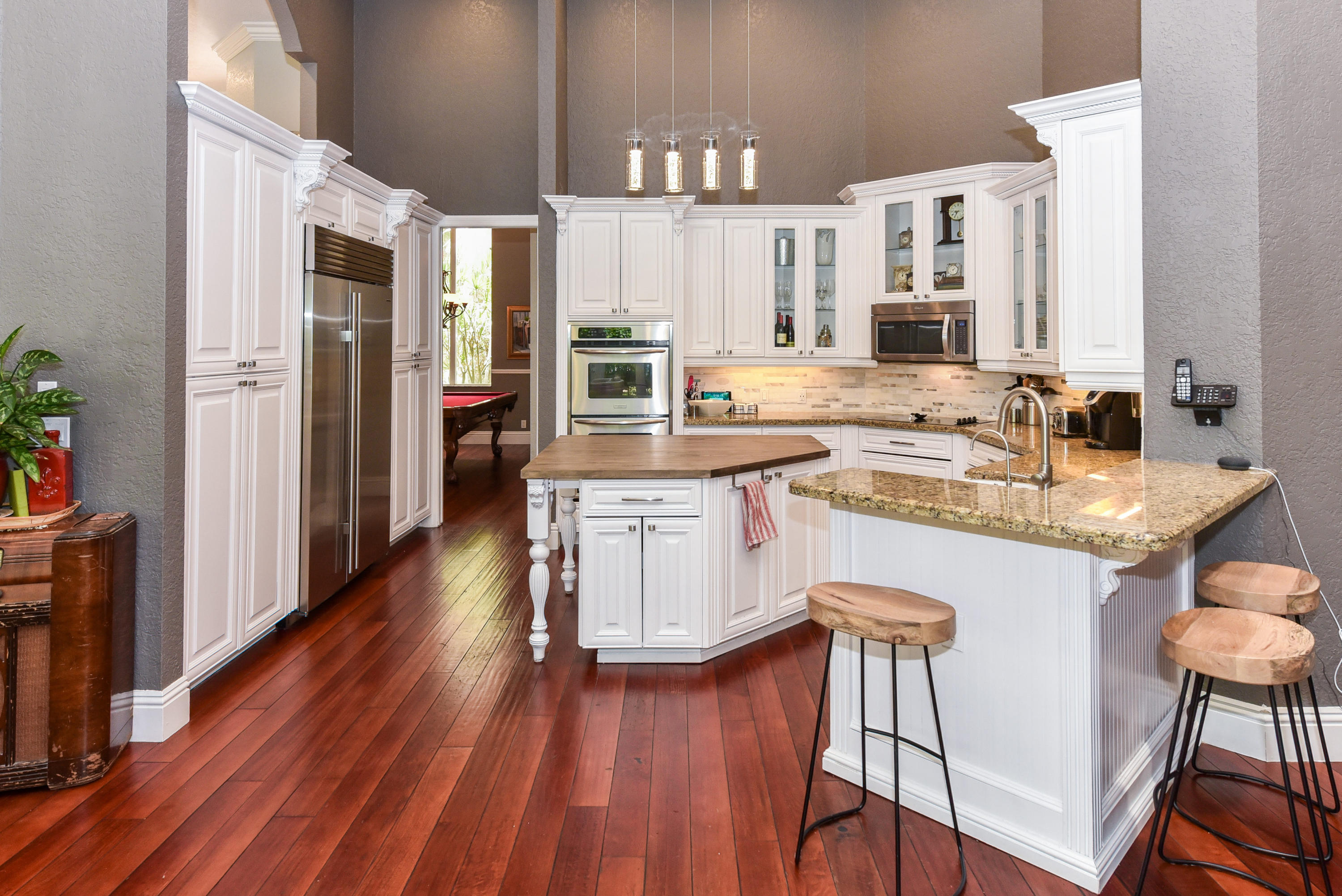 5855 Paddington Way Boca Raton, FL 33496 - Photo 13 of 40 a kitchen with a sink cabinets and wooden floor