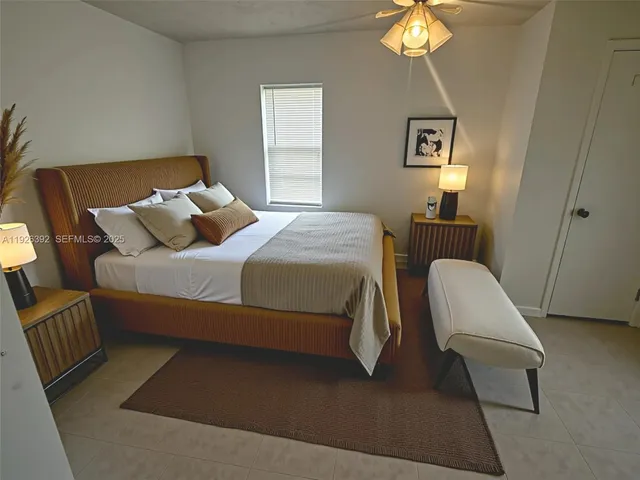 a bedroom with a bed and a chair