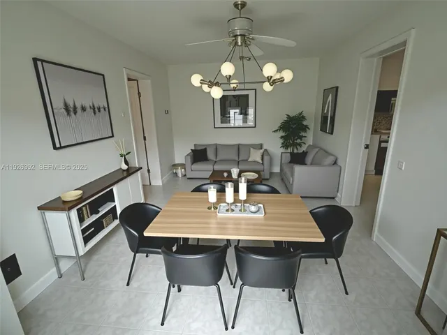 a view of a dining room with furniture and chandelier