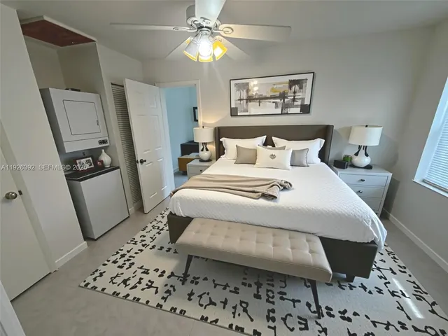 a bedroom with a bed and a mirror on dresser