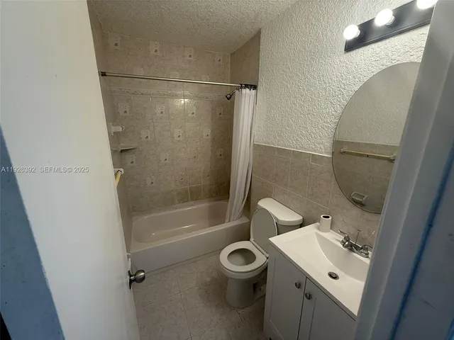 a bathroom with a sink a toilet and a shower