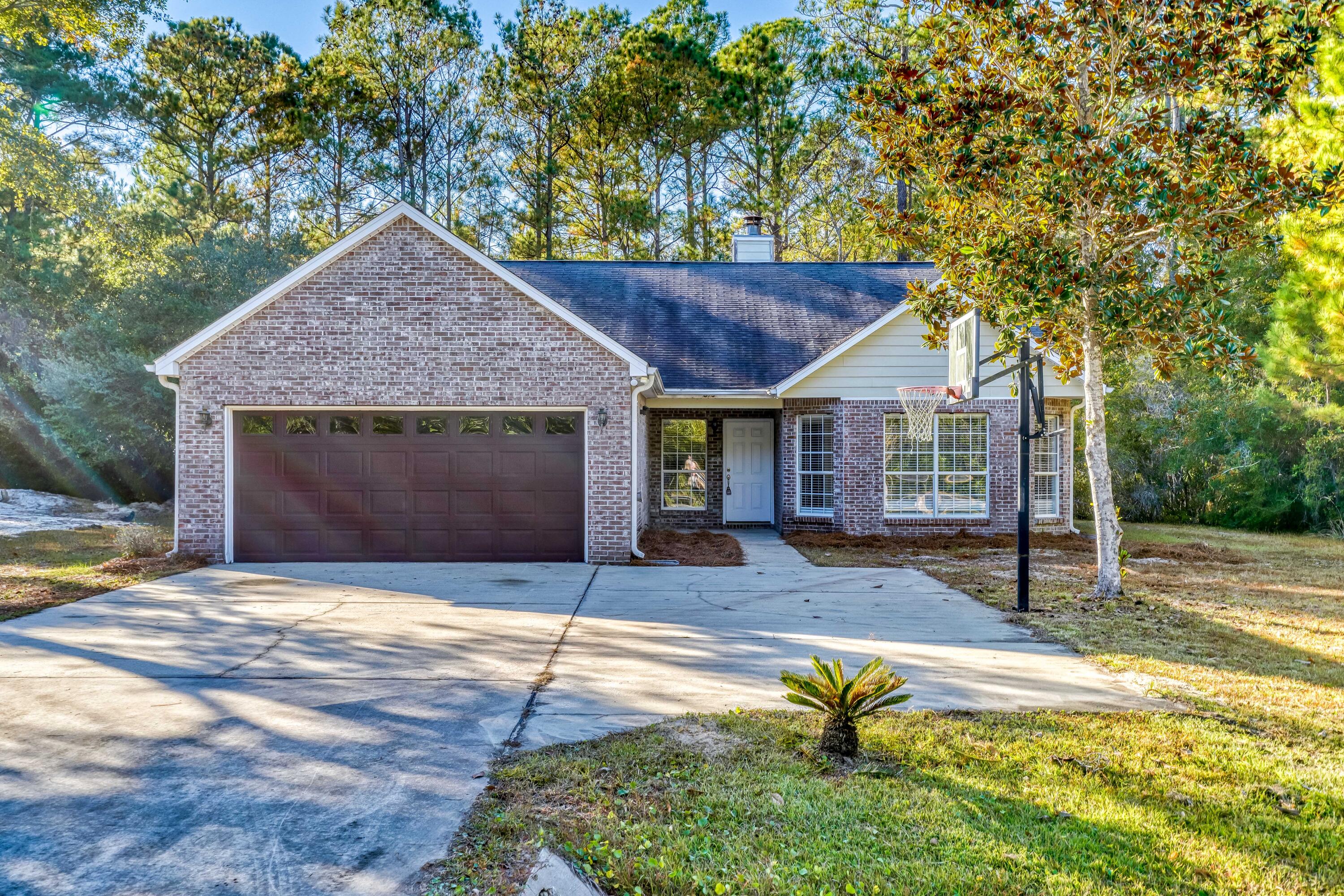 513 Bay Grove Road Freeport, FL 32439 - Photo 2 of 3 a house with trees in the background
