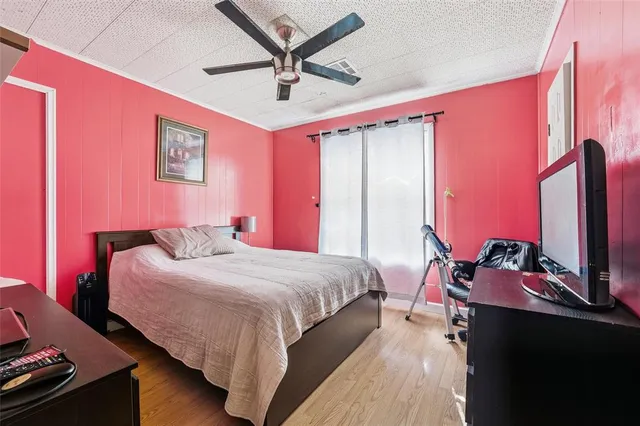 a bedroom with a bed and a mirror