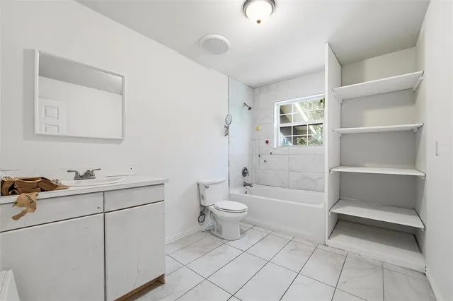a bathroom with a toilet sink and bathtub