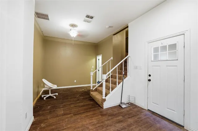 a view of entryway and hall with wooden floor