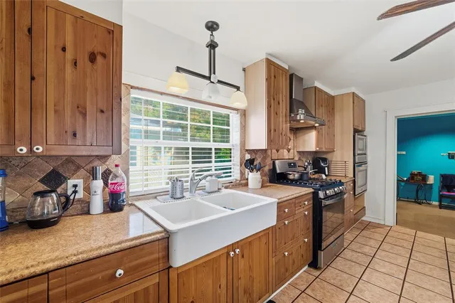 a kitchen with stainless steel appliances a sink stove and cabinets