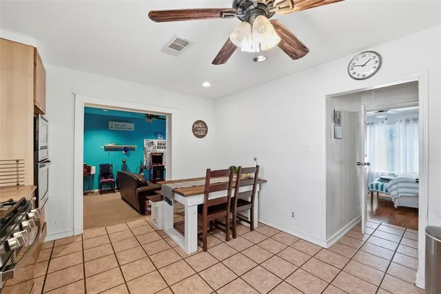 a lobby with furniture and a chandelier fan