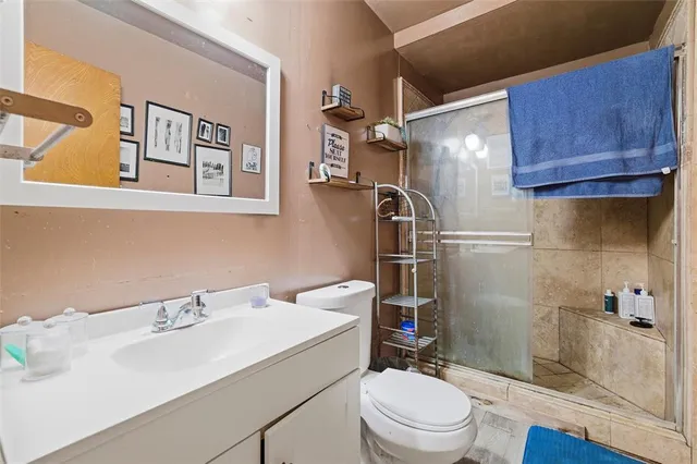 a bathroom with a sink toilet and shower