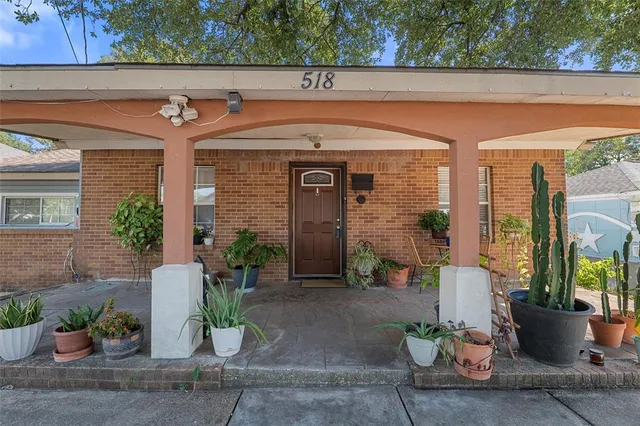 a front view of a house with potted plants