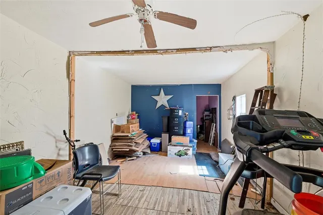 a view of a workspace with furniture and gym equipment