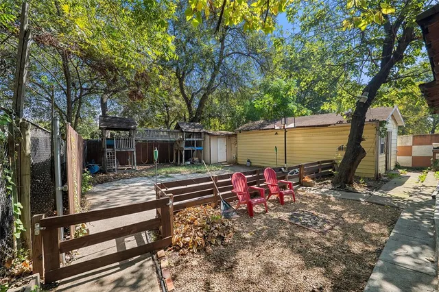 a view of house with backyard and seating space